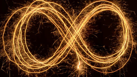the infinity symbol made up of strands of light