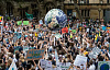protestors holding up a big globe of Planet Earth